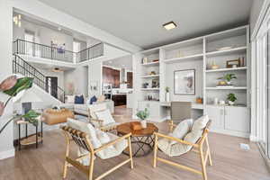 Living area with built in desk and light wood-type flooring