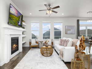 Living room with dark hardwood / wood-style flooring and ceiling fan