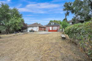 View of yard featuring a patio area, before fence was installed.