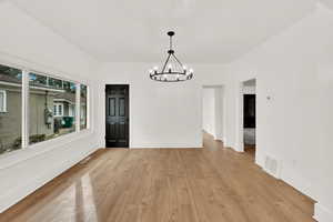 Dining area featuring an inviting chandelier and light hardwood / wood-style floors