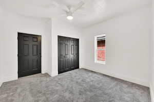 Bedroom with carpet floors, and a closet,.