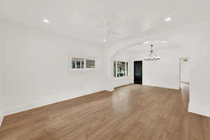 Main level living room with wood-type flooring  with notable chandelier