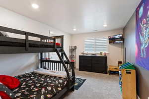 Basement Bedroom featuring carpet flooring and a textured ceiling