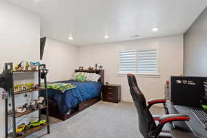 Basement Carpeted bedroom with a textured ceiling