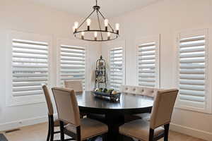 Dining space featuring an inviting chandelier and light hardwood / wood-style flooring