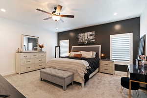 Primary Bedroom with light carpet and ceiling fan..  Barn Door Opening to Primary BA