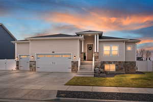 View of front of house with a yard and a garage