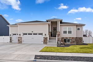 View of front of property featuring a garage and a front lawn