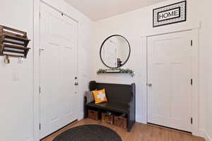 Entrance foyer with light hardwood / wood-style flooring