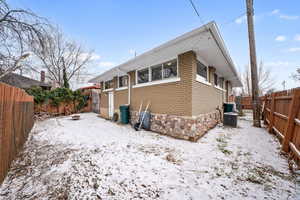 View of snowy exterior with cooling unit