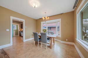 Tiled dining area with a chandelier