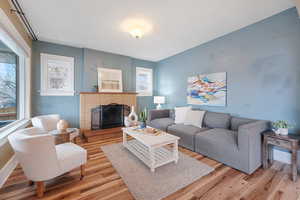 Living room with hardwood / wood-style flooring and a fireplace