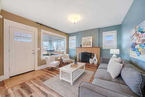 Living room featuring a brick fireplace and light hardwood / wood-style flooring