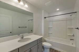 Full bathroom with toilet, vanity, bathtub / shower combination, and wood-type flooring