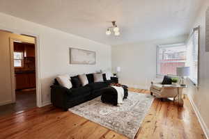 Living room featuring hardwood / wood-style flooring and a textured ceiling