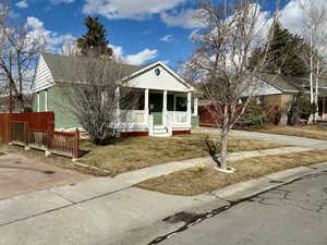 View of front of property with a porch and a front lawn