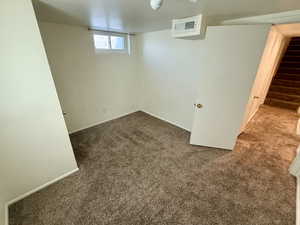 Basement with carpet flooring