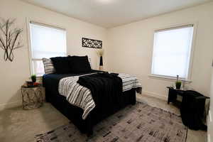 Bedroom featuring light colored carpet