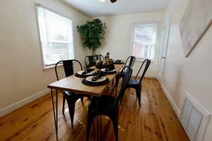 Dining room with light hardwood / wood-style flooring and ceiling fan