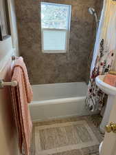 Bathroom featuring tile patterned flooring and shower / tub combo