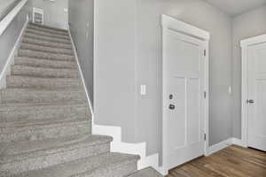 Staircase featuring wood-type flooring