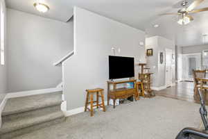 Living room with ceiling fan and carpet flooring