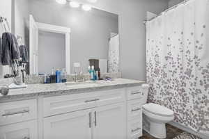 Bathroom with vanity, toilet, and LVP / wood-style floors