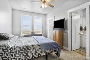 Bedroom featuring ceiling fan and ensuite bathroom