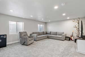 Living room with light carpet and a textured ceiling