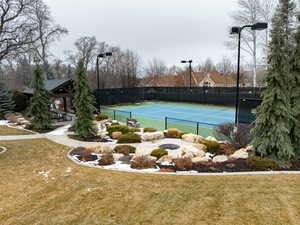 View of tennis court with a yard and a gazebo