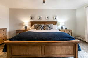 Carpeted bedroom featuring ceiling fan