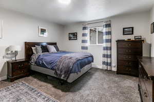 Bedroom with carpet flooring and a textured ceiling