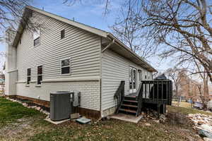 View of property exterior with central AC and a deck