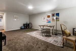 Dining area featuring carpet floors and a textured ceiling