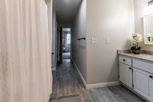 Corridor featuring dark hardwood / wood-style flooring