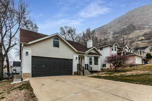 View of front facade with a garage and a mountain view