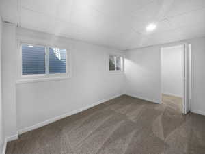 Carpeted spare room with a drop ceiling