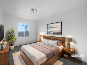 Bedroom featuring dark carpet