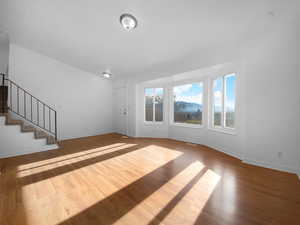 Unfurnished living room featuring light wood-type flooring