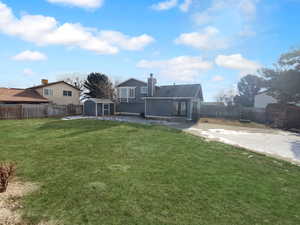 View of yard featuring a storage shed and a patio area