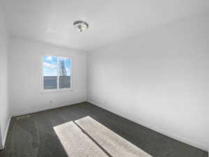 Spare room with dark carpet