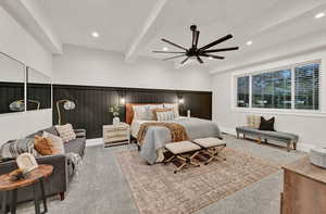 Primary bedroom with beamed ceiling and ceiling fan