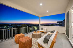 Balcony at dusk with an outdoor living space