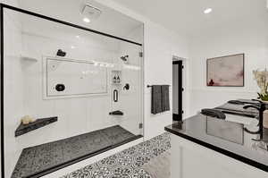 Primary Bathroom featuring a oversized shower with multiple shower heads.