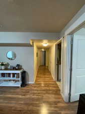 Corridor featuring dark wood-type flooring