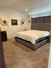 Carpeted bedroom with vaulted ceiling