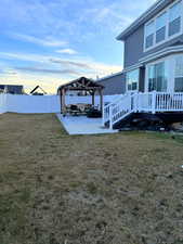 Yard at dusk with a gazebo and a patio area