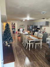 Dining room featuring dark hardwood / wood-style flooring and a textured ceiling