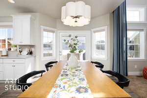 Dining space featuring a notable chandelier and baseboards