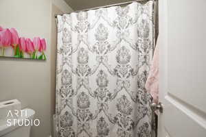 Full bath featuring curtained shower